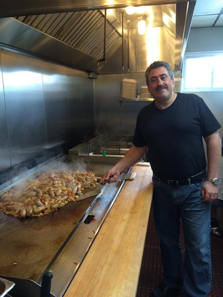 Mario cooking sausage and peppers on the grill